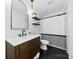 Bathroom featuring a modern vanity, elegant mirror, a toilet and a stylish shower curtain at 8438 Henry Harris Rd, Fort Mill, SC 29707