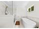 Bathroom showcasing a modern shower with glass door and a soaking tub with marble tile at 8438 Henry Harris Rd, Fort Mill, SC 29707