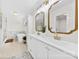 Bright bathroom featuring double sinks, large mirrors, tub, shower and modern finishes at 8438 Henry Harris Rd, Fort Mill, SC 29707