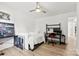 Bright bedroom features a bed and large desk with black metal frame and light wood floors at 8438 Henry Harris Rd, Fort Mill, SC 29707