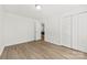 Spacious bedroom featuring light wood flooring, neutral walls, and a view into another room at 8438 Henry Harris Rd, Fort Mill, SC 29707