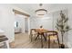 Cozy dining area featuring hardwood floors and a modern light fixture, perfect for intimate meals at 8438 Henry Harris Rd, Fort Mill, SC 29707