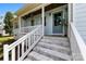 Inviting front porch with painted brick steps and white railings, complemented by hanging floral arrangements at 8438 Henry Harris Rd, Fort Mill, SC 29707