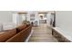 Bright living room showcasing hardwood floors, ample natural light, and an open layout flowing into the kitchen at 8438 Henry Harris Rd, Fort Mill, SC 29707