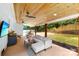 Charming covered patio with outdoor dining, living area, bar, and a spacious green backyard at 8438 Henry Harris Rd, Fort Mill, SC 29707