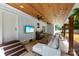 Stylish covered patio with TV, bar, and comfortable seating creating an ideal entertainment space at 8438 Henry Harris Rd, Fort Mill, SC 29707