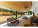 Inviting covered patio with ceiling fans, outdoor seating, bar, and a spacious backyard with a shed at 8438 Henry Harris Rd, Fort Mill, SC 29707