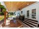 Relaxing covered patio with bar, ceiling fans, and easy access to the backyard via the staircase at 8438 Henry Harris Rd, Fort Mill, SC 29707