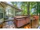 Back deck with hot tub leading to a charming screened in sunroom at 8701 Appaloosa Way Ln, Charlotte, NC 28216
