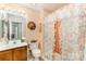 Cozy bathroom with peach accents and a floral shower curtain at 8701 Appaloosa Way Ln, Charlotte, NC 28216