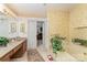 Well-lit bathroom boasts a vanity, soaking tub, and doorway to main bedroom at 8701 Appaloosa Way Ln, Charlotte, NC 28216