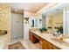 Bathroom with double sinks, warm lighting, and decorative accents at 8701 Appaloosa Way Ln, Charlotte, NC 28216