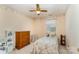 Charming bedroom with ceiling fan, floral accents, and a cozy bed at 8701 Appaloosa Way Ln, Charlotte, NC 28216