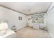 This bedroom includes a ceiling fan, closet, and a bright window at 8701 Appaloosa Way Ln, Charlotte, NC 28216