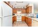 View of kitchen featuring white appliances, wood cabinetry, and tile flooring at 8701 Appaloosa Way Ln, Charlotte, NC 28216