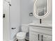 Bathroom featuring a white vanity with modern black fixtures and a lighted mirror at 10514 Harbor Dr, Charlotte, NC 28214