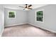Neutral bedroom with carpeted floors, two windows, a ceiling fan, and light gray walls at 10514 Harbor Dr, Charlotte, NC 28214