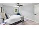 Cozy bedroom featuring a comfortable bed, neutral walls, a window, and a ceiling fan at 10514 Harbor Dr, Charlotte, NC 28214