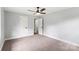 Bright bedroom with neutral walls, carpet, and white trim, offering a versatile and calming space at 10514 Harbor Dr, Charlotte, NC 28214