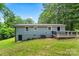 Back exterior of home featuring a backyard deck, walkout basement and blue siding at 10514 Harbor Dr, Charlotte, NC 28214