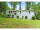 Charming single-story home with light blue painted brick and siding, complemented by fresh landscaping at 10514 Harbor Dr, Charlotte, NC 28214
