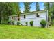 Charming one-story home with light blue painted brick, green lawn and mature trees at 10514 Harbor Dr, Charlotte, NC 28214