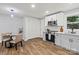 Updated kitchen with stainless steel appliances, light gray cabinets, and wood floors at 10514 Harbor Dr, Charlotte, NC 28214