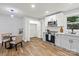 Modern kitchen featuring white cabinets, stainless steel appliances, and open layout for easy entertaining at 10514 Harbor Dr, Charlotte, NC 28214