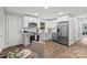 Modern kitchen with stainless steel appliances, light gray cabinets and wood floors at 10514 Harbor Dr, Charlotte, NC 28214