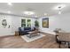 Open concept living room with wood floors, modern decor, a sofa and a dining area at 10514 Harbor Dr, Charlotte, NC 28214