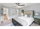 Bright main bedroom featuring a ceiling fan, neutral walls, a large bed and a window at 10514 Harbor Dr, Charlotte, NC 28214