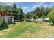 View of house exterior with lawn and several sheds at 107 Skyuka Rd, Statesville, NC 28677