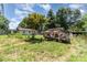 View of house exterior with lawn and trailer filled with debris at 107 Skyuka Rd, Statesville, NC 28677