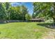 Expansive backyard with a lush green lawn and a home featuring a covered patio at 107 Skyuka Rd, Statesville, NC 28677