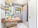 Small bathroom with window, shower with patterned curtain, and white hexagon tile floor at 107 Skyuka Rd, Statesville, NC 28677