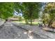 A large gravel driveway leads to a home with a covered patio and spacious backyard at 107 Skyuka Rd, Statesville, NC 28677
