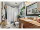 Bright bathroom featuring granite vanity, bathtub with shower, and patterned tile floor at 111 Beacon Hills Dr, Gastonia, NC 28056