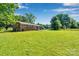 Large backyard featuring lush grass and mature trees creating a private retreat at 113 Lou Dr, Gastonia, NC 28052