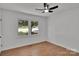 Bright bedroom with hardwood floors, a ceiling fan, and a large window at 113 Lou Dr, Gastonia, NC 28052