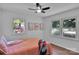 Cozy bedroom with hardwood floors, a ceiling fan, and two large windows at 113 Lou Dr, Gastonia, NC 28052