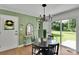 Dining room features a sleek table and chairs, a modern chandelier, and sliding glass doors at 113 Lou Dr, Gastonia, NC 28052