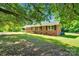 Charming brick home featuring manicured lawn and classic black shutters at 113 Lou Dr, Gastonia, NC 28052