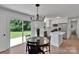 Open-concept kitchen and dining area with stainless steel appliances and a view of the lush backyard at 113 Lou Dr, Gastonia, NC 28052