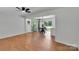 Spacious living area featuring refinished hardwood floors and an open concept layout to the dining area at 113 Lou Dr, Gastonia, NC 28052