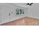 Bright living room featuring hardwood floors, a ceiling fan, and a large window at 113 Lou Dr, Gastonia, NC 28052