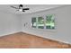 Bright living room featuring hardwood floors, a ceiling fan, and a large window at 113 Lou Dr, Gastonia, NC 28052
