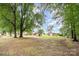 Expansive backyard with mature trees, and home in the background at 1145 Earl Rd, Shelby, NC 28152