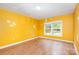Bedroom features yellow walls, wood floors, and a window for natural light at 1145 Earl Rd, Shelby, NC 28152