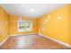Bedroom features yellow walls, wood floors, and a window for natural light at 1145 Earl Rd, Shelby, NC 28152