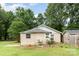 Quaint home exterior shows an expansive yard and mature tree coverage at 1145 Earl Rd, Shelby, NC 28152